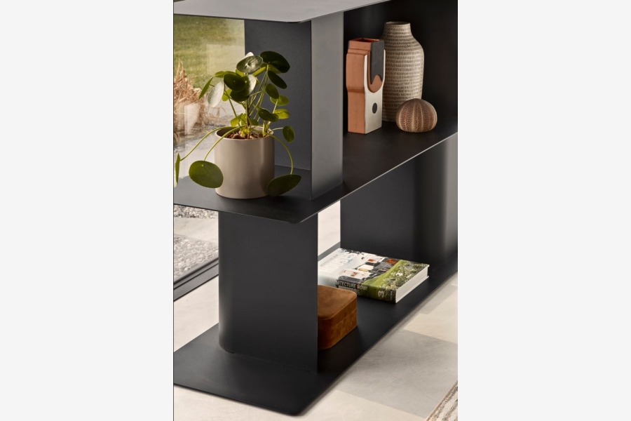Detail van een zwart metalen open kast met een plant op een van de legplanken.