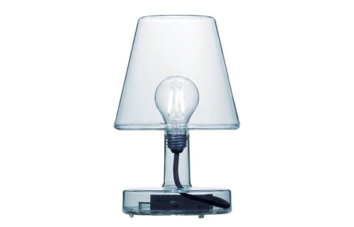 Transparante tafellamp met zichtbare gloeilamp en zwarte fitting, op een witte a