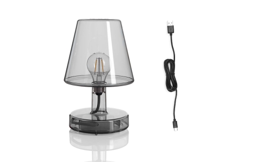 Transparante draadloze tafellamp met zichtbare gloeilamp en zwarte USB-oplaadkab