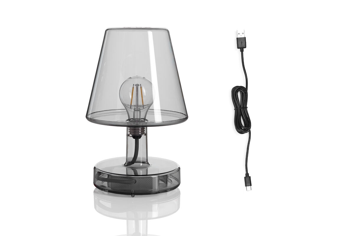 Transparante draadloze tafellamp met zichtbare gloeilamp en zwarte USB-oplaadkab